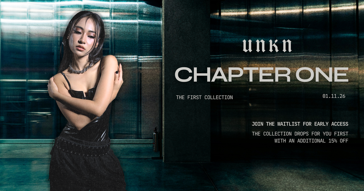 UNKN Chapter One genderless stainless steel jewelry campaign featuring a model wearing a chain necklace and black outfit, promoting the collection waitlist.
